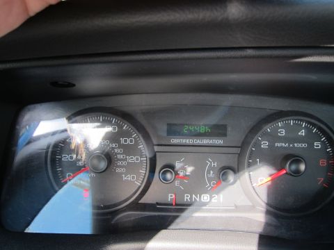 2001 Ford Crown Victoria - Interior view of dashboard gauges, including speedometer, tachometer, fuel, and temperature indicators.