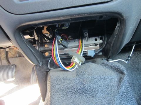 2001 Ford Crown Victoria - Wiring harness and connectors are visible beneath the dashboard of a vehicle.