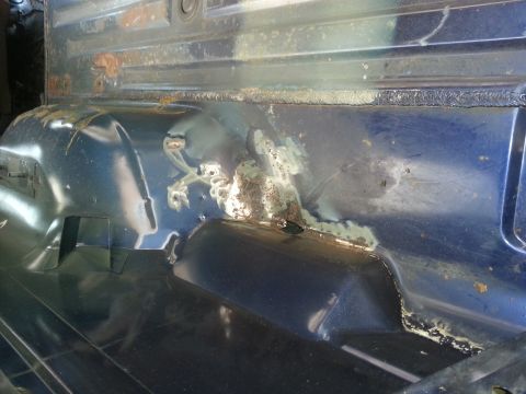 1994 Ford Bronco - Interior view of a vehicle's floor pan showing significant rust and corrosion damage.