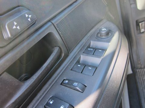 2001 Ford Crown Victoria - Close-up of a car's interior door panel, showing various electronic controls for windows and mirrors.