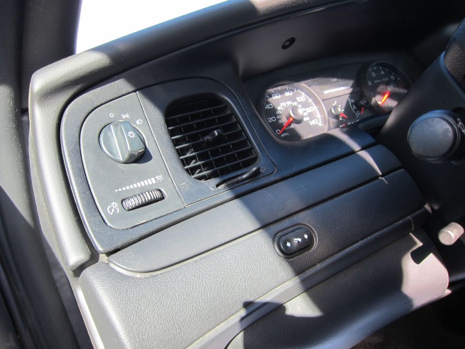 2001 Ford Crown Victoria interior showing dashboard with headlight controls, air vent, and speedometer