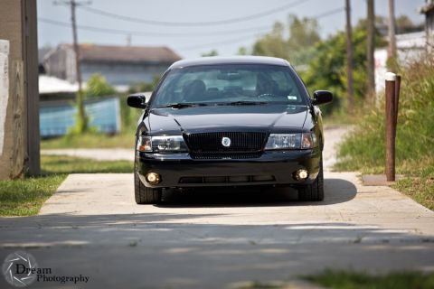 2003 Mercury Marauder - A black 2003 Mercury Marauder is shown from the front, parked on a driveway with a blurred background.