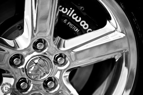 2003 Mercury Marauder - Close-up of a chrome wheel with a Mercury emblem and a Wilwood 6 piston brake caliper.