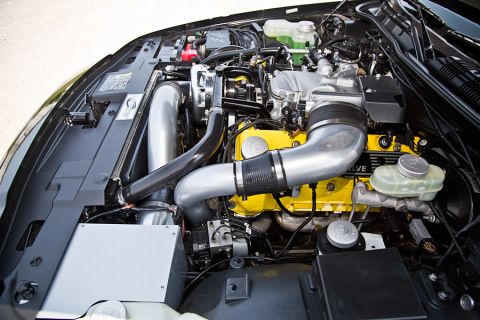 2003 Mercury Marauder - Customized engine bay yellow valve covers and prominent intake plumbing.