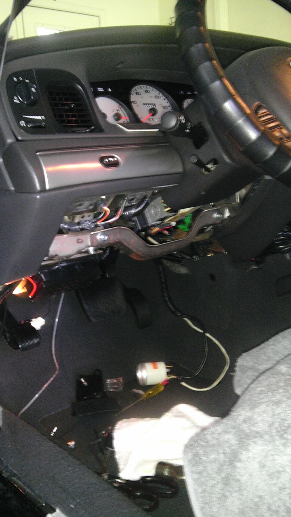 Dashboard and steering wheel of a 2003 Mercury Marauder with wiring exposed under the dash