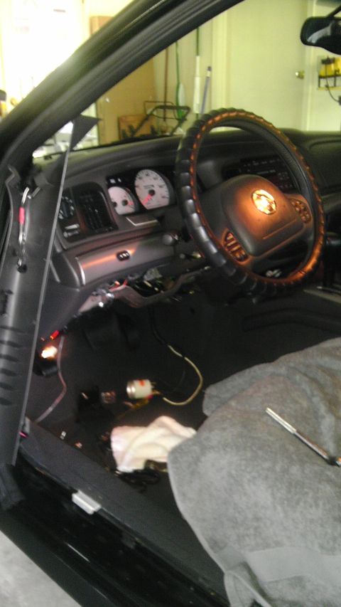 2003 Mercury Marauder - The interior of a 2003 Mercury Marauder is visible, with the dashboard and steering wheel in focus and wiring exposed on the floor.