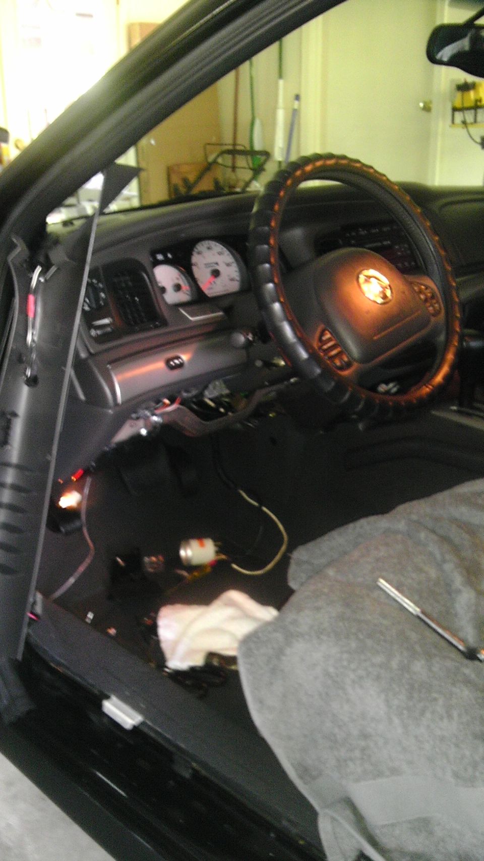 2003 Mercury Marauder interior showing dashboard, steering wheel with emblem, and exposed wiring on the floor