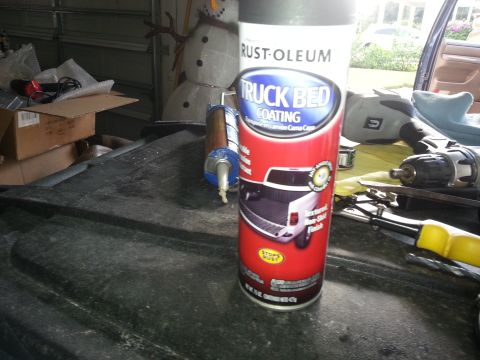 1994 Ford Bronco - A can of Rust-Oleum truck bed coating sits on a surface, with tools and a snowman decoration in the background.