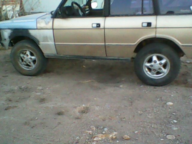 1991 Land Rover Range Rover side view, tan body with primer on front fender