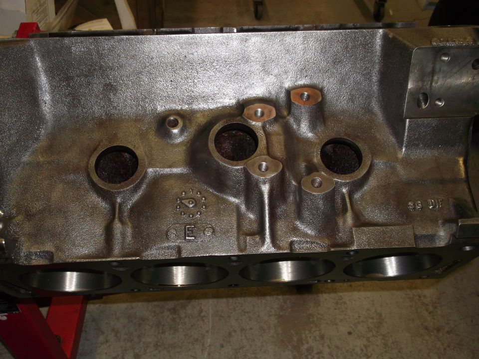 Close-up of a cast iron engine block with cylinder bores visible