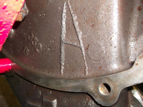 1967 Ford Mustang - A close-up view of a cast metal component shows a prominent letter 'A' and some stamped numbers.