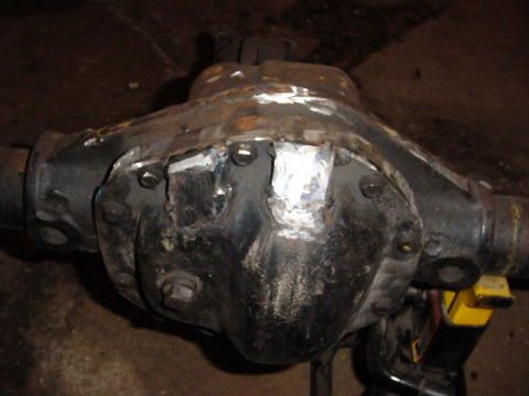 1992 Ford Bronco - A close-up view of a differential housing that has undergone modifications, including welded sections and visible bolts.