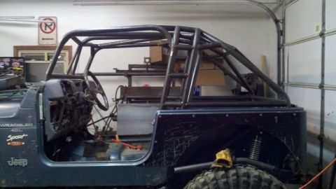 1985 Jeep CJ7 - Custom roll cage installed in a Jeep Wrangler interior. The vehicle appears to be undergoing modifications.
