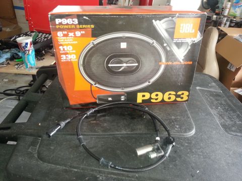 1994 Ford Bronco - A JBL P963 car speaker and an ABS sensor are displayed on a black surface.