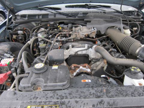 2001 Ford Crown Victoria - Engine bay of a vehicle, showing various mechanical parts and wiring.