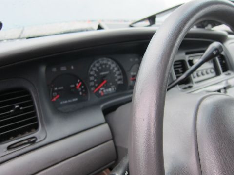 2001 Ford Crown Victoria - Interior view of a 2001 Ford Crown Victoria, focusing on the dashboard and steering wheel.