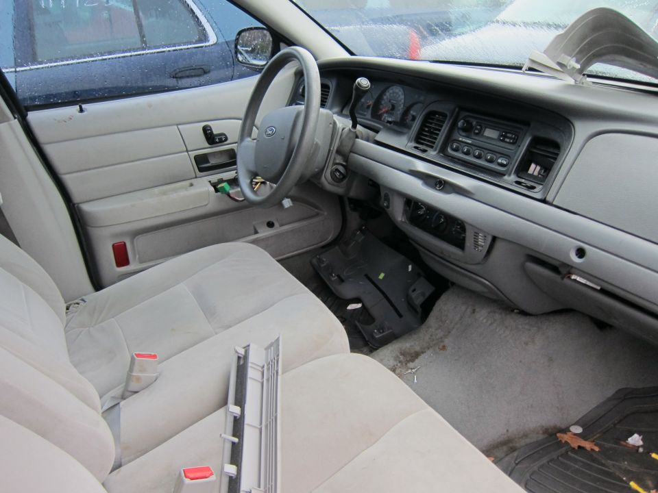 Interior of a 2001 Ford Crown Victoria showing dashboard and seats