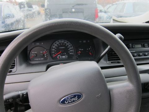 2001 Ford Crown Victoria - The interior of a 2001 Ford Crown Victoria, the steering wheel, dashboard, and gauges.