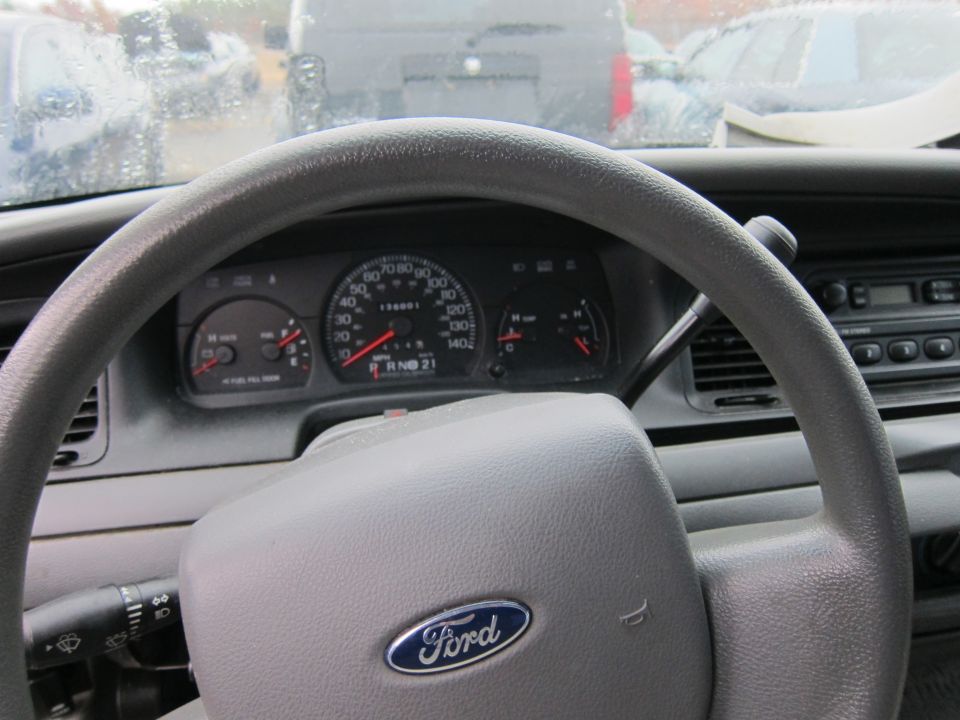 2001 Ford Crown Victoria interior with Ford steering wheel and dashboard gauges