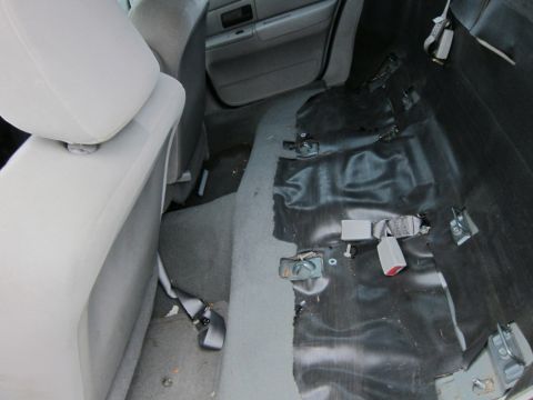 2001 Ford Crown Victoria - Interior view of a 2001 Ford Crown Victoria with rear seats removed, revealing the floor and mounting hardware.