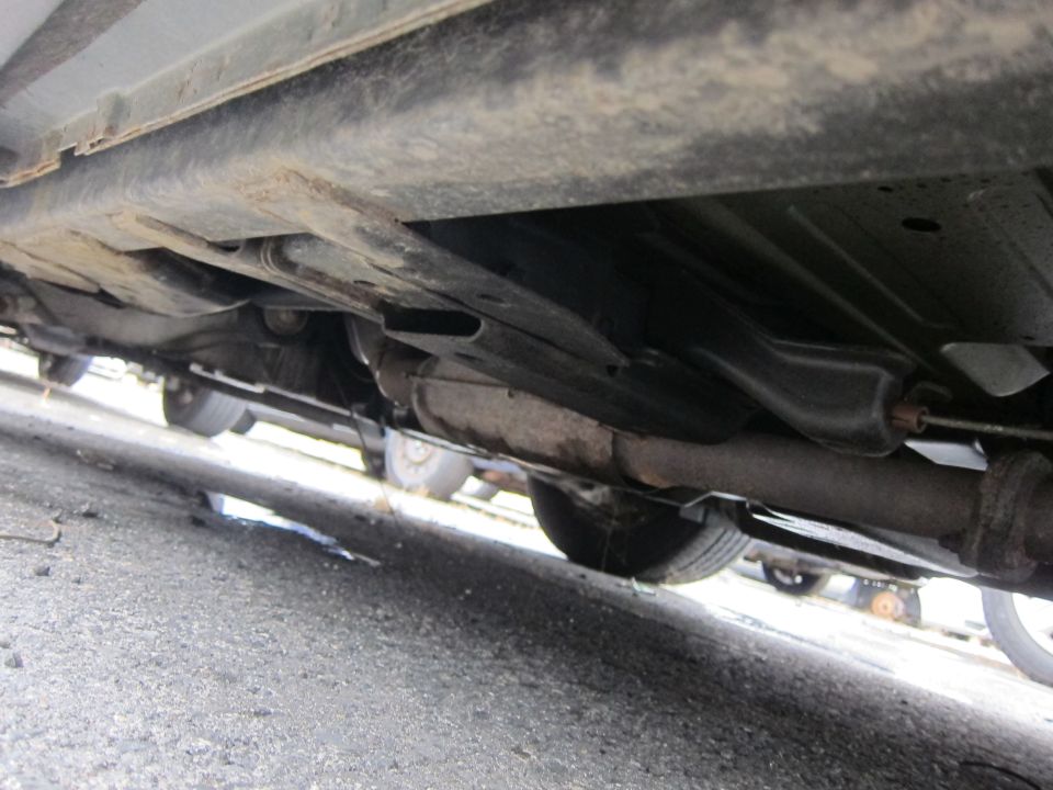 Underside view of a car showing the exhaust system and suspension components