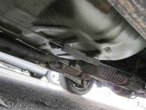 2001 Ford Crown Victoria - View of the undercarriage of a vehicle, revealing the exhaust system and suspension.