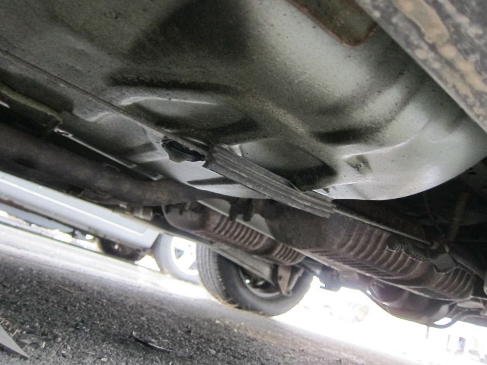 Underside of a car showing exhaust system and suspension components
