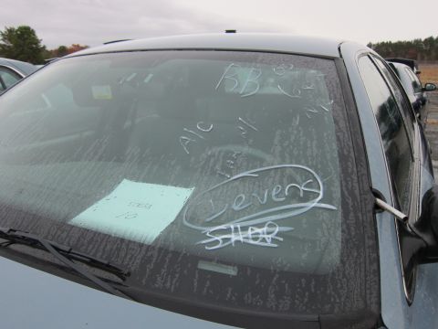 2001 Ford Crown Victoria - Windshield displays handwritten notes and a paper tag, with other vehicles visible in the background.