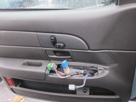 2001 Ford Crown Victoria - Interior view of a car door panel, showing exposed wiring and electrical connectors near the door handle.