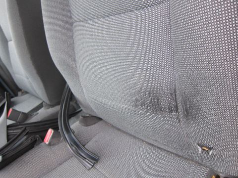 2001 Ford Crown Victoria - Interior view of gray fabric car seats, showing wear and a detached trim piece.