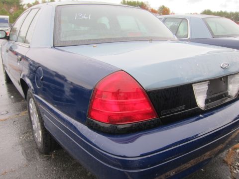 2001 Ford Crown Victoria - A blue Ford Crown Victoria is parked outdoors, with another vehicle visible behind it.