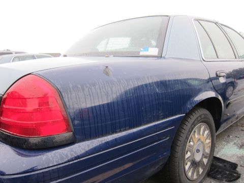 2001 Ford Crown Victoria - Rear view of a blue 2001 Ford Crown Victoria, showing the quarter panel and taillight.