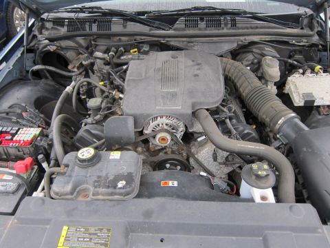2001 Ford Crown Victoria - Engine bay of a 2001 Ford Crown Victoria, showing the V8 engine and associated components.