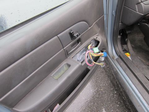 2001 Ford Crown Victoria - The interior door panel shows exposed wiring and window controls, indicating a potential issue or modification.