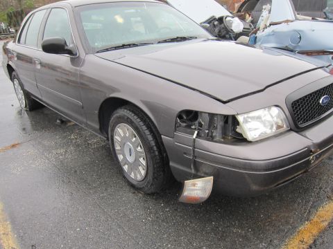 2001 Ford Crown Victoria - This 2001 Ford Crown Victoria shows damage to the front end, including a missing headlight and a detached turn signal.