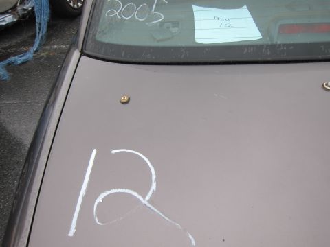 2001 Ford Crown Victoria - Car trunk with handwritten markings on the window and lid.