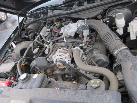 2001 Ford Crown Victoria - The engine bay of a vehicle, showing various components and wiring.