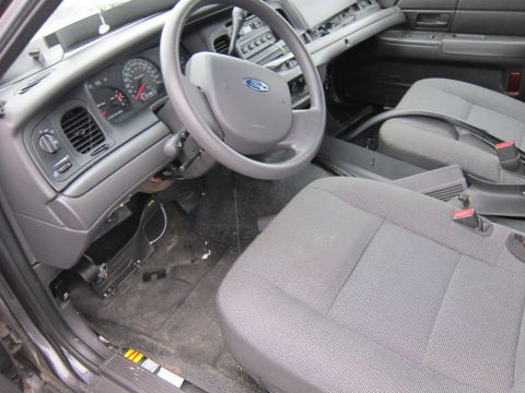 2001 Ford Crown Victoria - Interior view of a 2001 Ford Crown Victoria, highlighting the dashboard and seating.