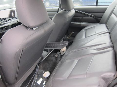 2001 Ford Crown Victoria - The interior of a police vehicle, focusing on the rear seating area and the floor console.