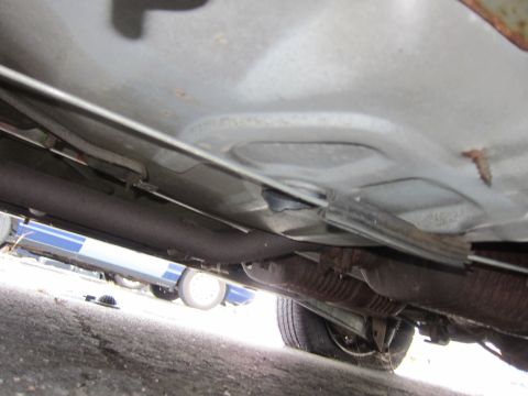 2001 Ford Crown Victoria - The underside of a vehicle is visible, revealing the exhaust system and various frame components.
