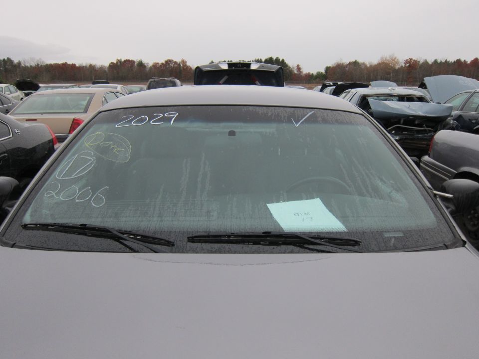Windshield with chalk markings '2006' and '2029', and a paper slip