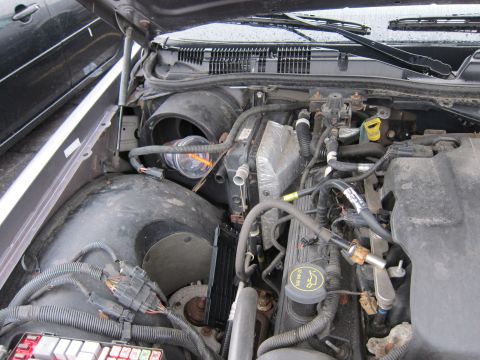 2001 Ford Crown Victoria - The engine bay of a vehicle, showing various components and wiring.