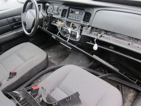 2001 Ford Crown Victoria - The interior of a 2001 Ford Crown Victoria shows a dismantled dashboard and exposed wiring.