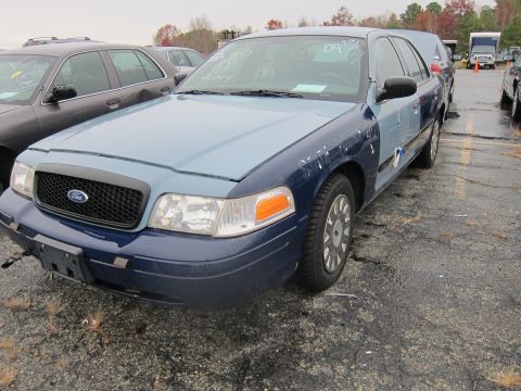 2001 Ford Crown Victoria - Ford Crown Victoria with mismatched body panels, text on windshield indicates 2004.