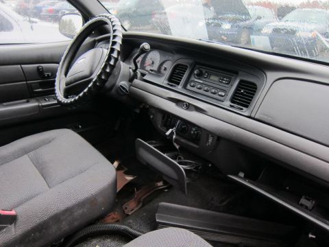 2001 Ford Crown Victoria - Interior view of a 2001 Ford Crown Victoria, showing the dashboard, steering wheel, and front seats.