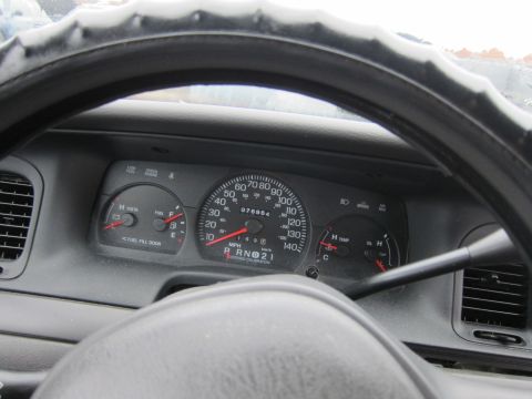 2001 Ford Crown Victoria - The interior dashboard of a 2001 Ford Crown Victoria shows the odometer reading 076964 miles, along with fuel and temperature gauges.