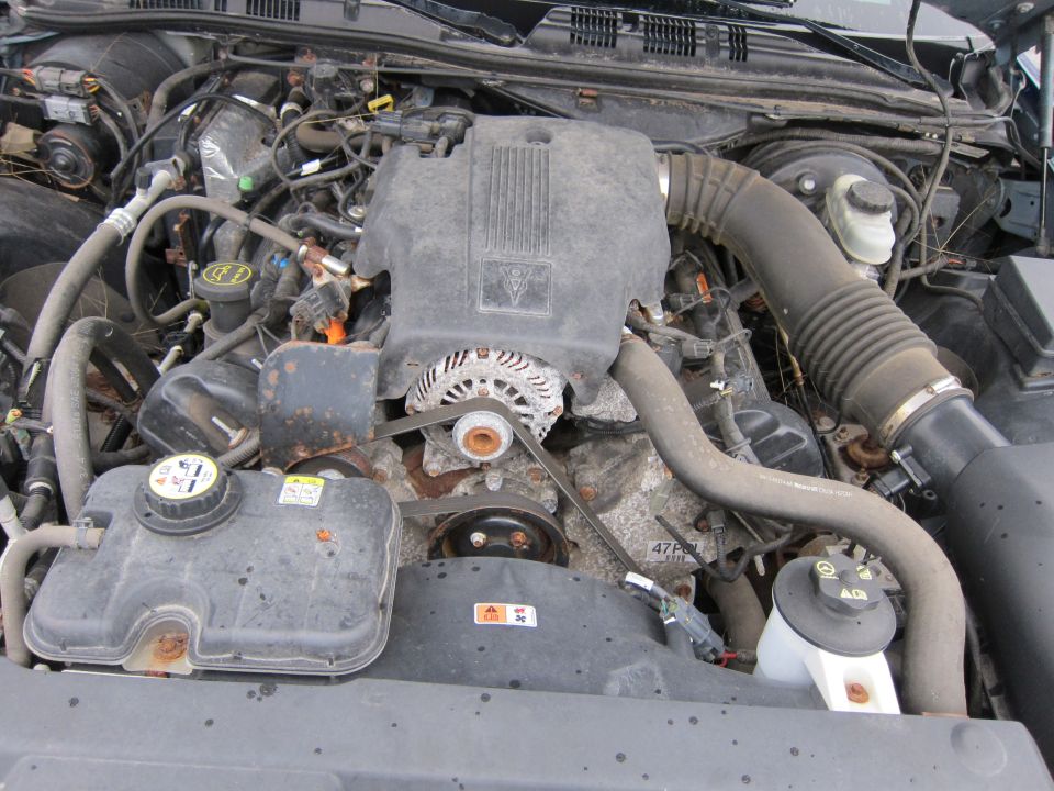 Engine bay with alternator, air intake, and coolant reservoir