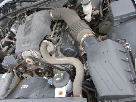2001 Ford Crown Victoria - Close-up view of a vehicle's engine bay, showing various mechanical parts.