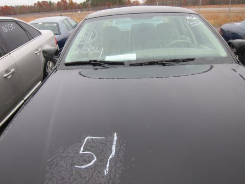 2001 Ford Crown Victoria - A black sedan is shown from the front, with chalk markings on the windshield and hood.