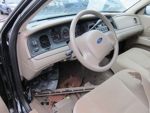 2001 Ford Crown Victoria - The interior of a 2001 Ford Crown Victoria is shown, with the dashboard and steering wheel visible.